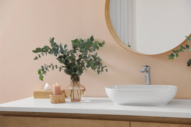 istock Eucalyptus branches near vessel sink on bathroom vanity. Interior design 1793641729