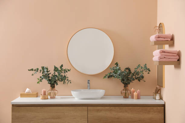 istock Stylish mirror, eucalyptus branches and vessel sink in modern bathroom. Interior design 1793642793