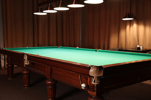 Empty green billiard table in club. Pool Game