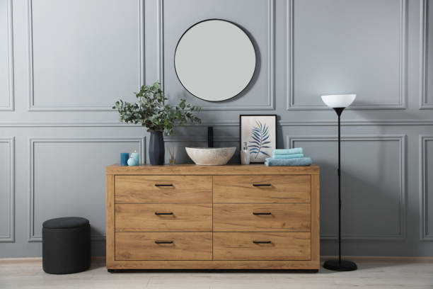 istock Modern bathroom interior with stylish mirror, eucalyptus branches, vessel sink and wooden vanity 1793643338