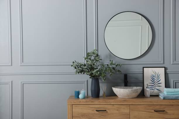 istock Folded towels, burning candles and eucalyptus branches near vessel sink on bathroom vanity. Interior design 1793644978