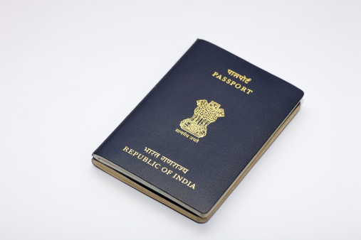 An Indian frequent traveller's passport on a white background.  An additional passport has been issued and attached to the original passport.  This is often done by the Indian Passport Authority to allow the holder to have more pages.  The new booklet is attached to the older one as there may be valid visas in it.