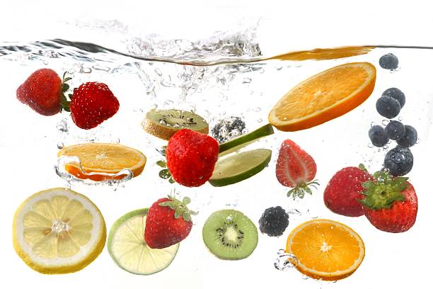 istock Many Fruits Falling Into Splashing Clear Water 179365350