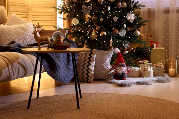 istock Beautiful Christmas tree and gift boxes in festively decorated room 1793662415