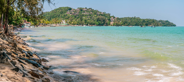 Panorama view at coastline with sandy beach line covered by high tide water. Scenic tropical seascape view, Thailand resort area - Bang Thao beach