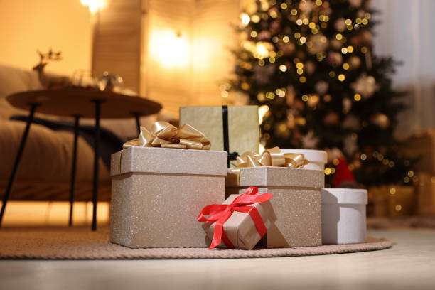 istock Beautiful gift boxes in room decorated for Christmas. Bokeh effect 1793662428