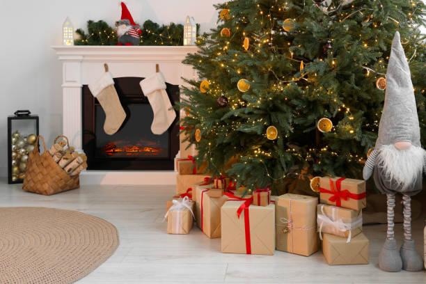 istock Many different gift boxes under Christmas tree and festive decor in living room 1793665278
