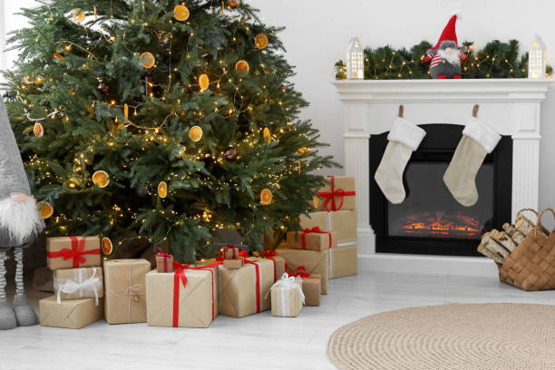 istock Many different gift boxes under Christmas tree and festive decor in living room 1793665401
