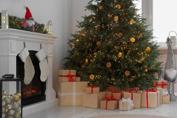 istock Many different gift boxes under Christmas tree and festive decor in living room 1793666944