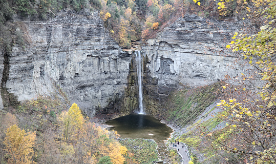 waterfall at Taughannock Falls State Park (huge beautiful gorge) Finger Lakes (Ithaca, New York State) autumn view with fall foliage (colorful changing leaves) stone, rock, slate, glacial formed