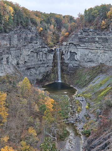 waterfall at Taughannock Falls State Park (huge beautiful gorge) Finger Lakes (Ithaca, New York State) autumn view with fall foliage (colorful changing leaves) stone, rock, slate, glacial formed