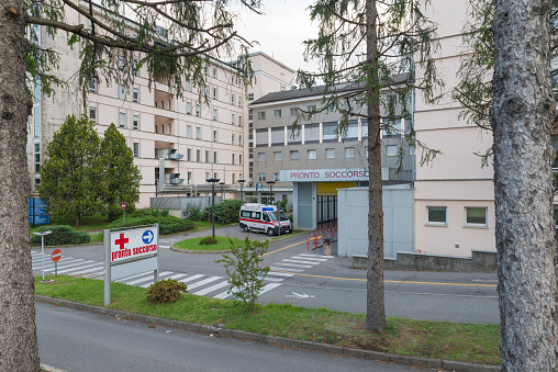 Tradate, Italy – May 15, 2023: Galmarini hospital of Tradate city, emergency room entrance with a parked ambulance