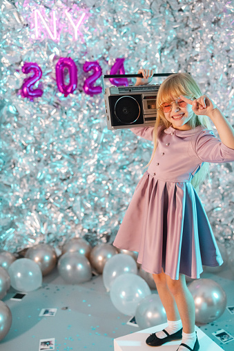 Photo of a well-dressed girl celebrating New Year in an old-fashioned way
