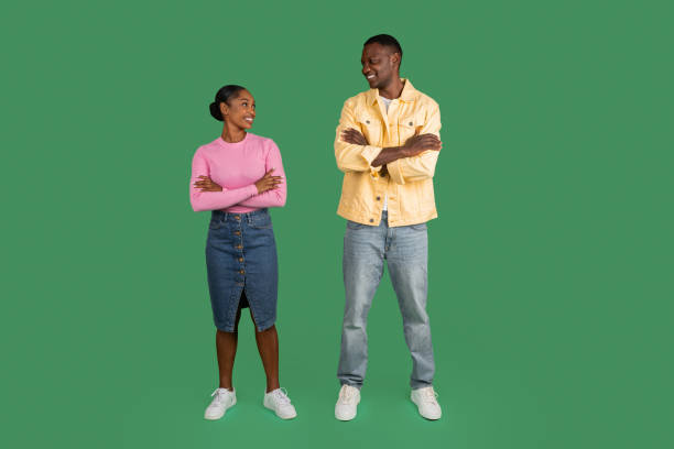 istock Happy young black couple looking at each other on green 1793754464