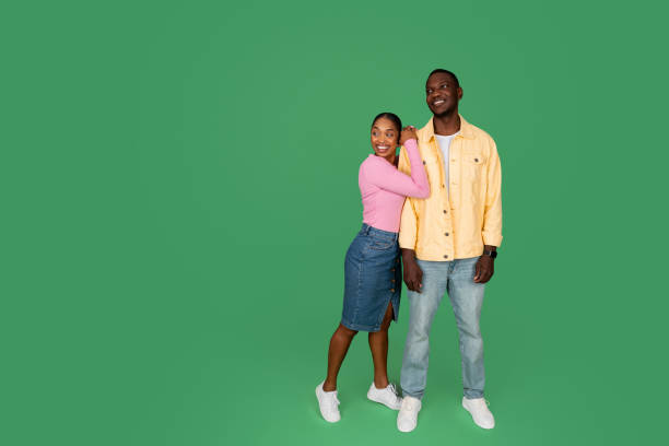 istock Loving african american couple looking at copy space, colored background 1793754468