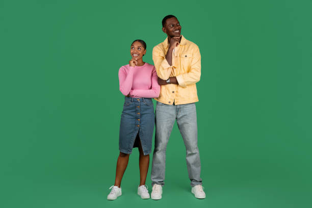 istock Excited curious young black man and woman posing on green 1793754504