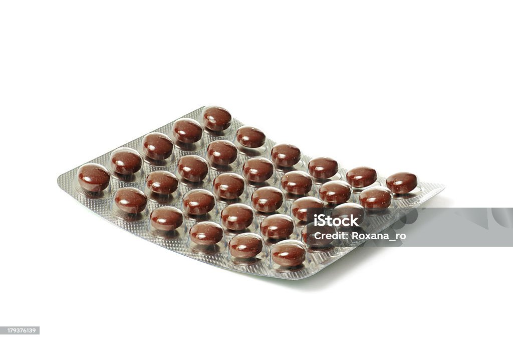 Paquete con comprimidos de color marrón - Foto de stock de Adicción libre de derechos