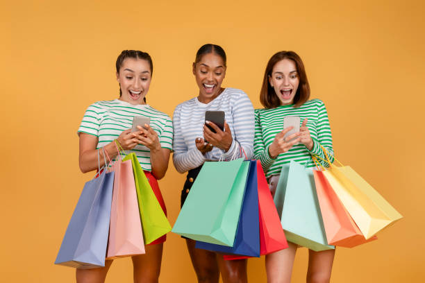 istock Amazed three young multiethnic ladies shopping online, using smartphones 1793761948