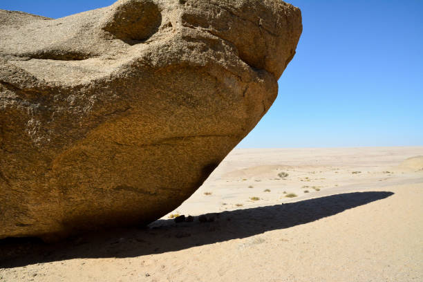 istock A huge rocky boulder lies in the desert under a blue sky 1793770956