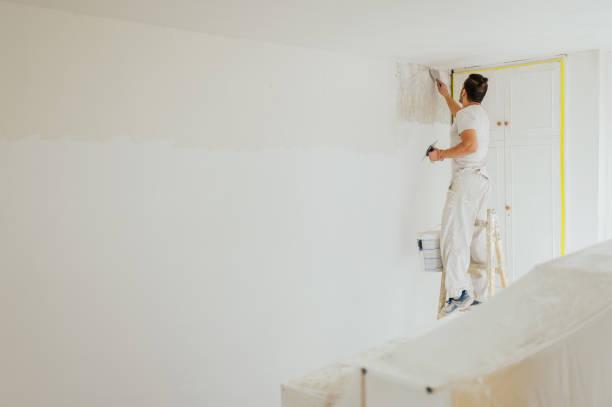 istock A plasterer on ladder skim coating and plastering walls. 1793784005