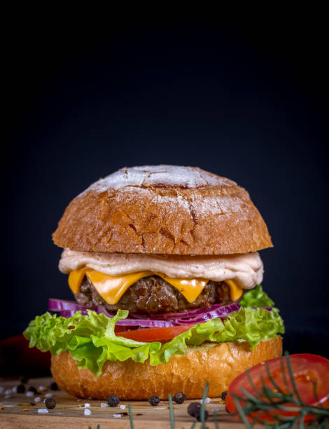 istock Beef burger with lettuce, tomato, cheddar cheese and onion 1793796256