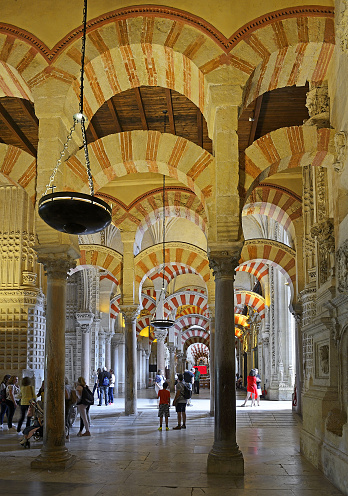 Cordoba, Spain – May 3, 2019.  Mesmerizing arches inside the Great Mosque of Cordoba or Cathedral-Mosque of Cordoba - UNESCO World Heritage Site, Spain - beautifully decorated interiors, an example of magnificent Islamic art and architecture