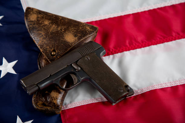 istock Antique firearm with holster resting on American Flag 1793811590