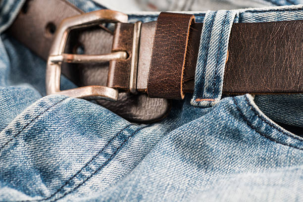 istock used blue jeans with brown belt 179383918