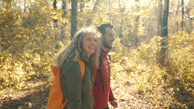 Young couple romantically walking through the forest.