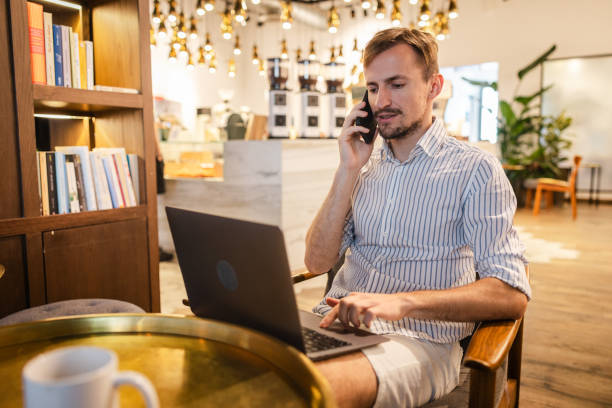istock Handsome young white man doing work on a laptop in a cafe 1793849542