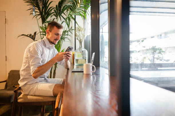 istock Handsome young white man doing work on a laptop in a cafe 1793850203