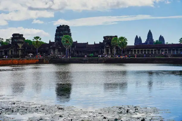 Angkor Wat Temple skyline against a bright blue sky with clouds at mid day at Siem Reap, Cambodia, Asia