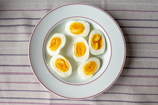 Hardboiled eggs on a plate on a table.