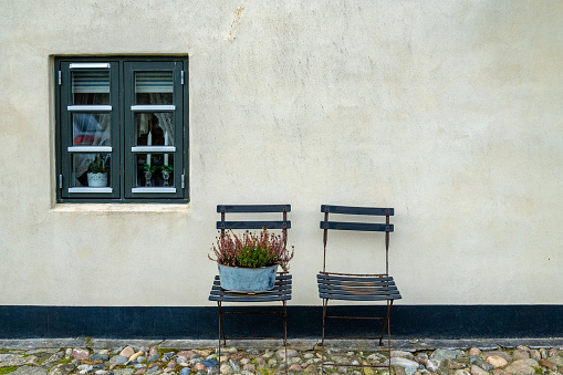 Lonstrup, Denmark Two garden chairs outside a small cottage and window