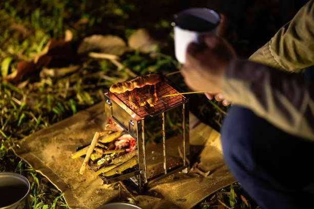Close-up of barbecue meal grill in the wilderness of backpacker group. Grilled meals ready to eat for hiking groups, Camping in nature, Cooking at night with an atmosphere that is warm and inviting.