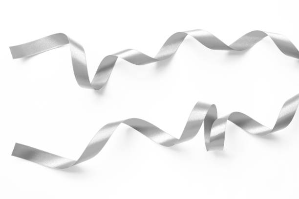 istock Silver ribbon satin bow scroll set isolated on white background with clipping path for Christmas and wedding card confetti design decoration 1793887045