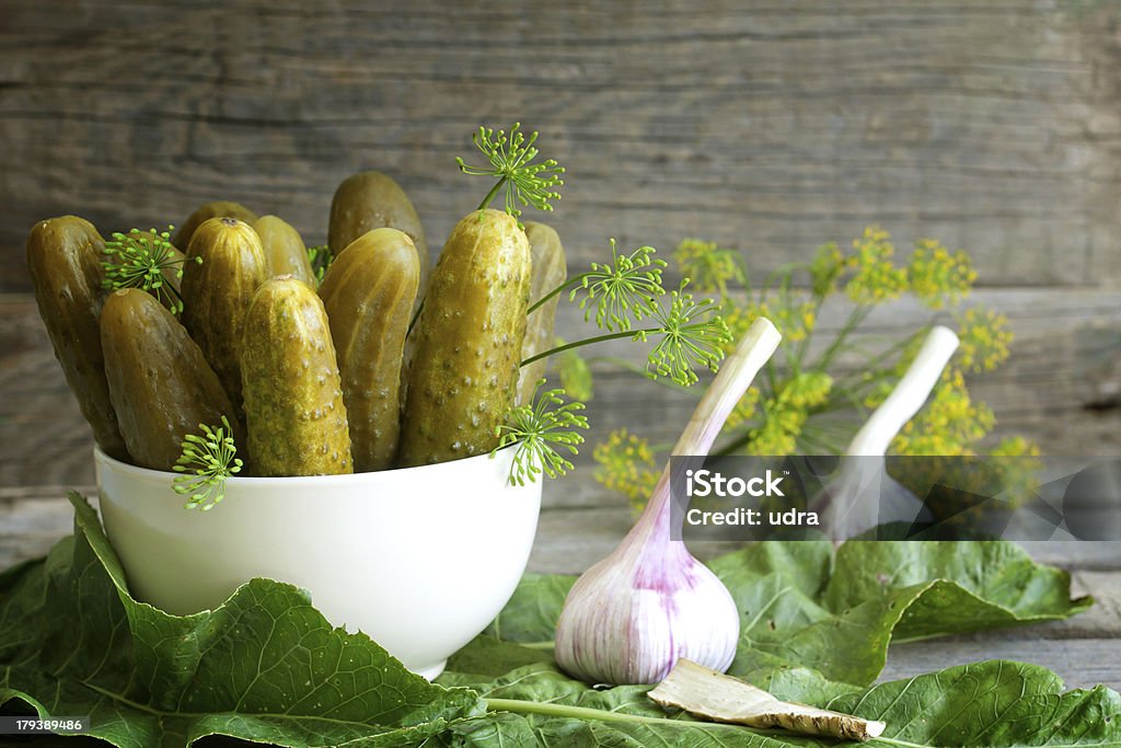 Pickles gherkins salted cucumbers still life Pickles gherkins salted cucumbers still life on old planks Close-up Stock Photo