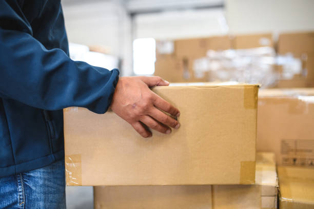 istock Asian Courier Holding A Cardboard Parcel 1793895985