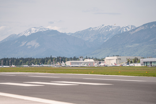Airfield and an idyllic airport under the alps in the backgroud.