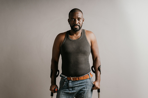 Portrait of a black man using crutches