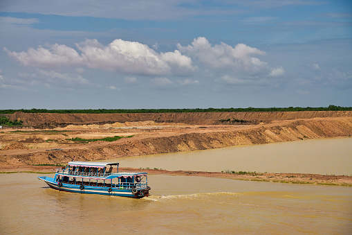 Trawler on Siem Reap river carrying goods upstream at Siem Reap, Cambodia, Asia