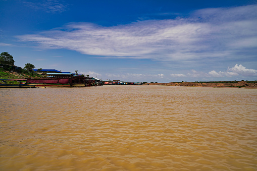 Muddy Siem Reap river flowing to Tonle Sap Lake at Siem Reap, Cambodia, Asia