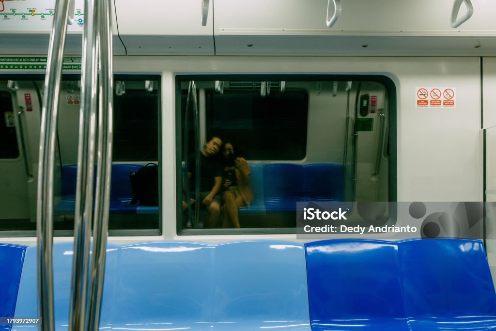 Asian Couple taking Selfie in Empty MRT Train Indonesian Traveler in Singapore Lifestyles Stock Photo