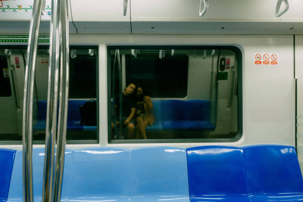 Asian Couple taking Selfie in Empty MRT Train stock photo