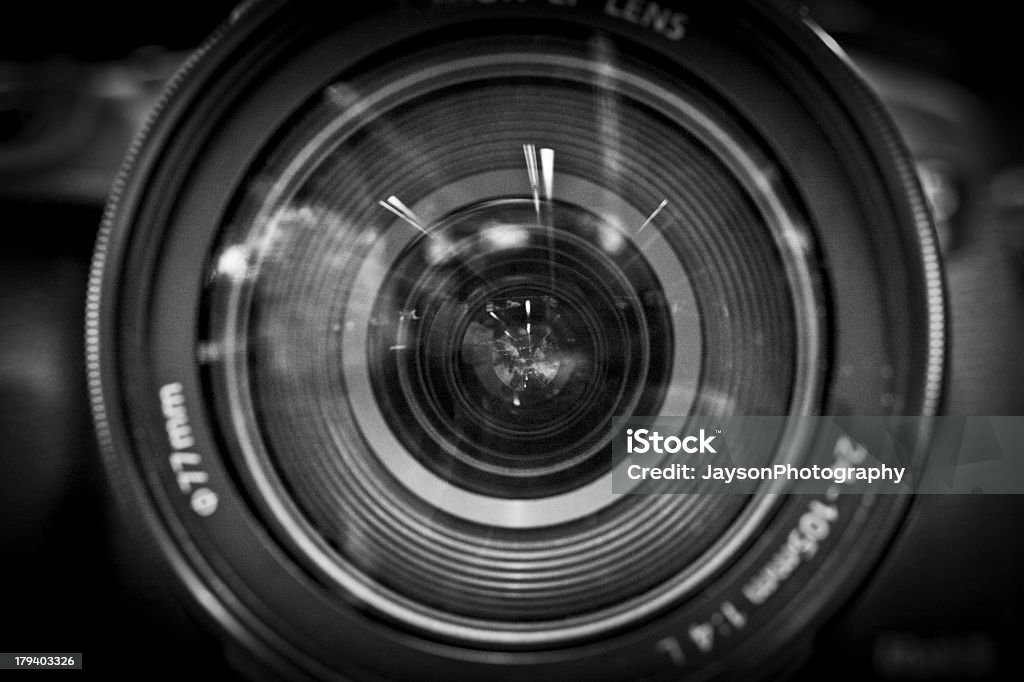 A close-up black and white image of a camera lens Close up view on a camera lens with UV filter Black And White Stock Photo