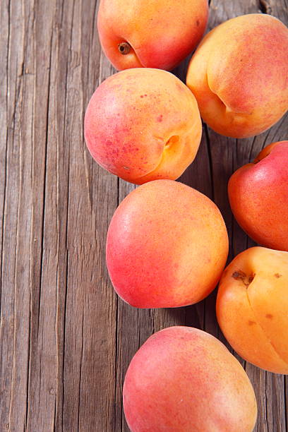 plums on wooden background stock photo