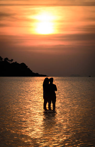 istock Couple watching sunset at the sea 179406265