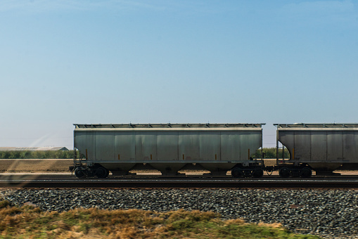 Railcars on tracks along California Route 99 near Bakersfield, California, USA