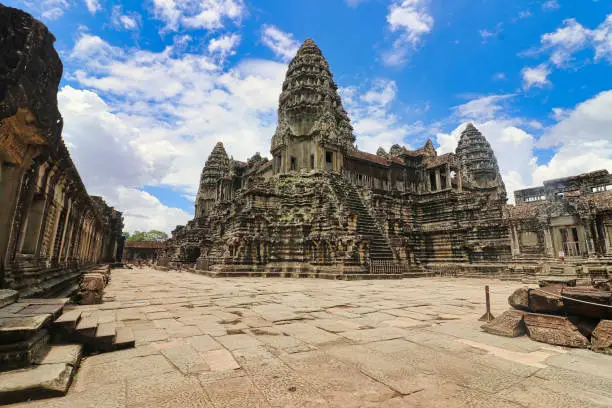 Angkor Wat Temple Inner Pyramid Complex, masterpiece of Khmer Architecture built in 12th century by Suryavarman II against a bright blue sky at Siem Reap, Cambodia, Asia