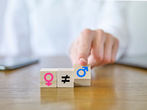 Businesswoman giving gender equality message with icons on cubic blocks
